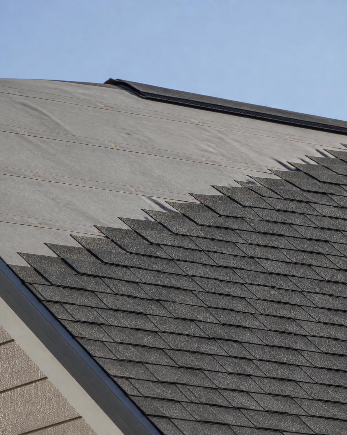 Roof decking with underlayment and architectural shingle courses partially installed